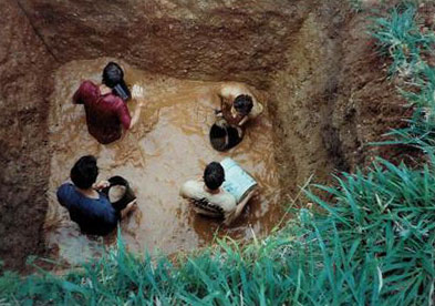 Students bailing water out of Huyck House trash pit.